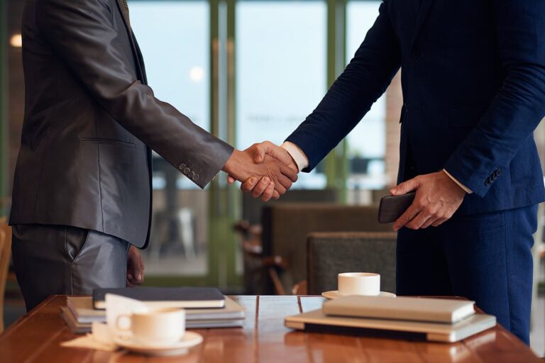 bloombergquint2F2025-05-292Fpqns80812Fmid-section-two-unrecognizable-businessmen-shaking-hands-fi.jpeg